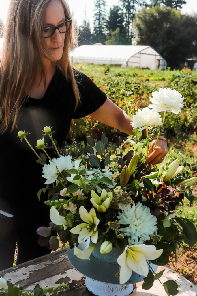 A farmer-florist creating wedding flowers in a vase.